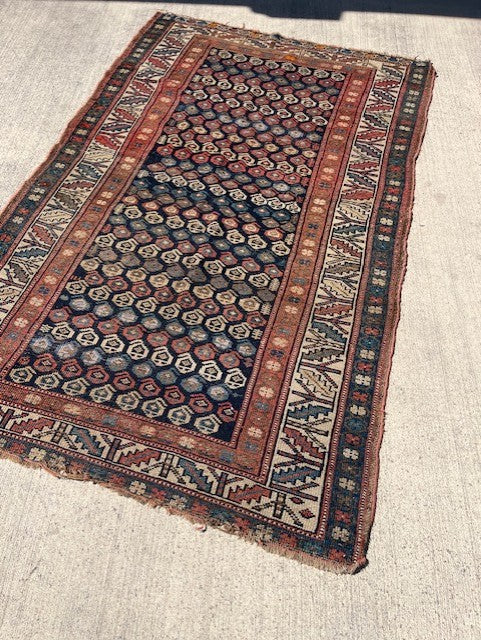Antique Persian Village rug with navy field and overall Boteh design