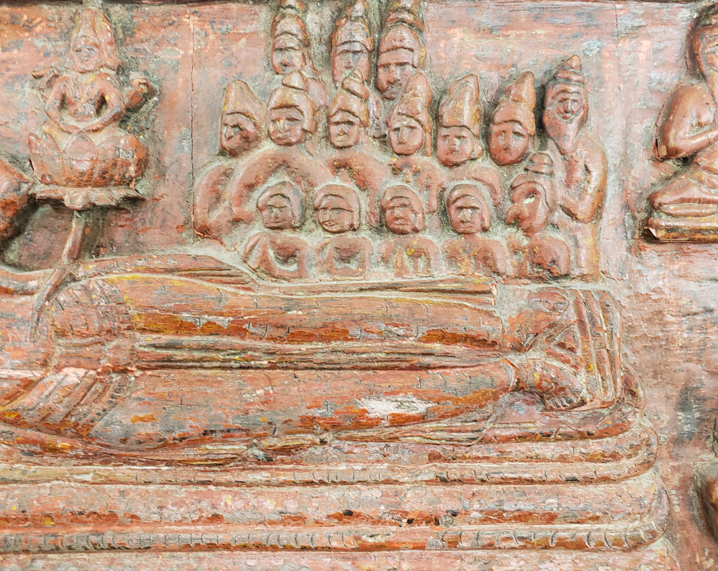 Antique heavily carved Buddhist panel with an old and original red painted surface