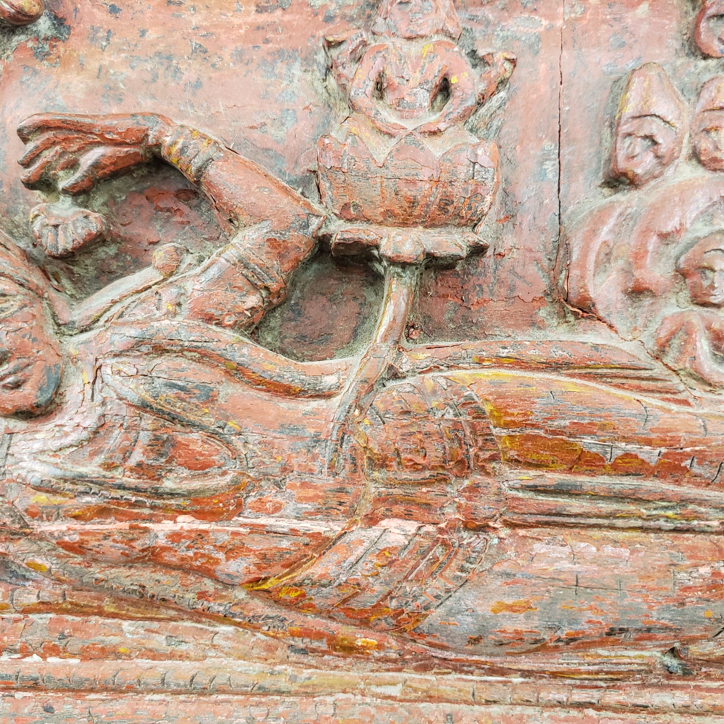 Antique heavily carved Buddhist panel with an old and original red painted surface