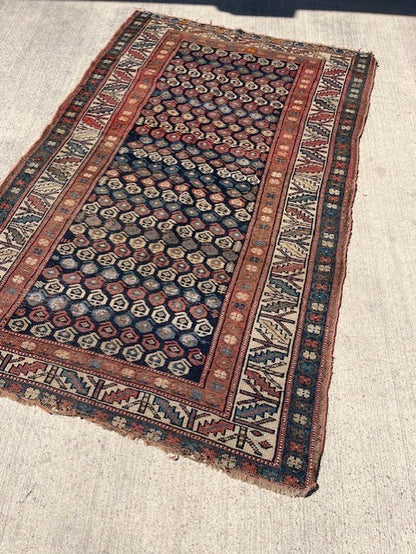 Antique Persian Village rug with navy field and overall Boteh design