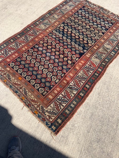 Antique Persian Village rug with navy field and overall Boteh design