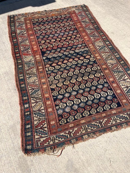 Antique Persian Village rug with navy field and overall Boteh design