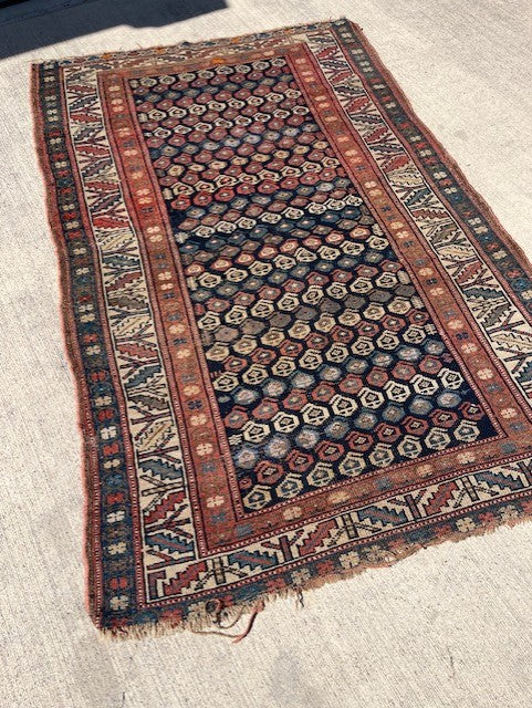Antique Persian Village rug with navy field and overall Boteh design