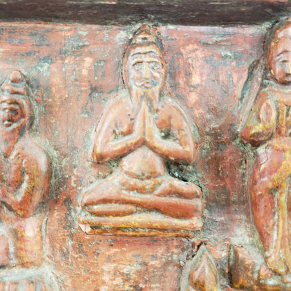 Antique heavily carved Buddhist panel with an old and original red painted surface