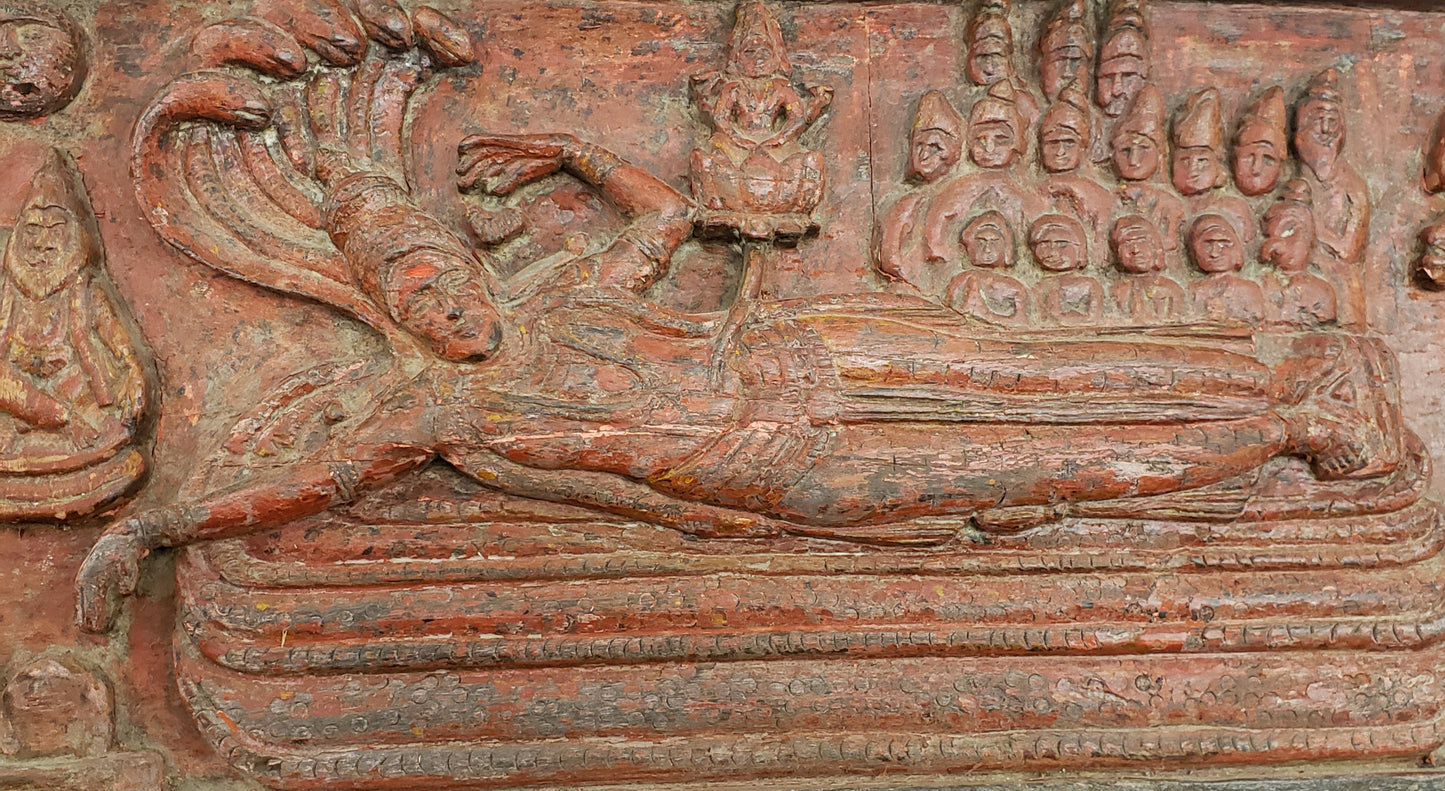 Antique heavily carved Buddhist panel with an old and original red painted surface