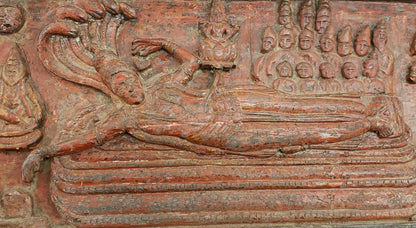 Antique heavily carved Buddhist panel with an old and original red painted surface